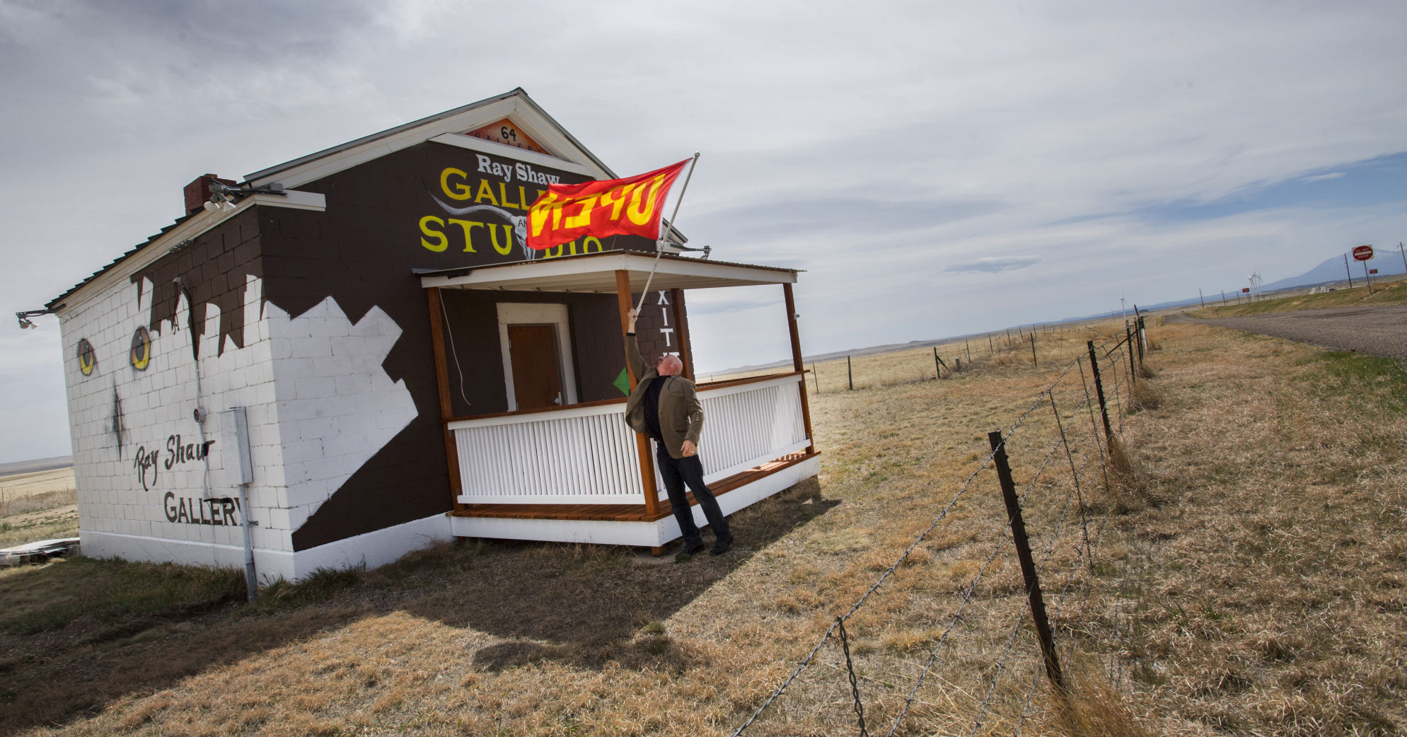 Artist Ray Shaw closes shop in his gallery near Exit 64 along Interstate 25 north of Waslenburg, Wednesday, April 11, 2018. Shaw raises the flag as he works in his small studio next to the highway. (The Gazette, Christian Murdock) (copy)